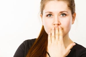 woman covering her mouth