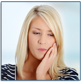 woman holding her jaw in pain